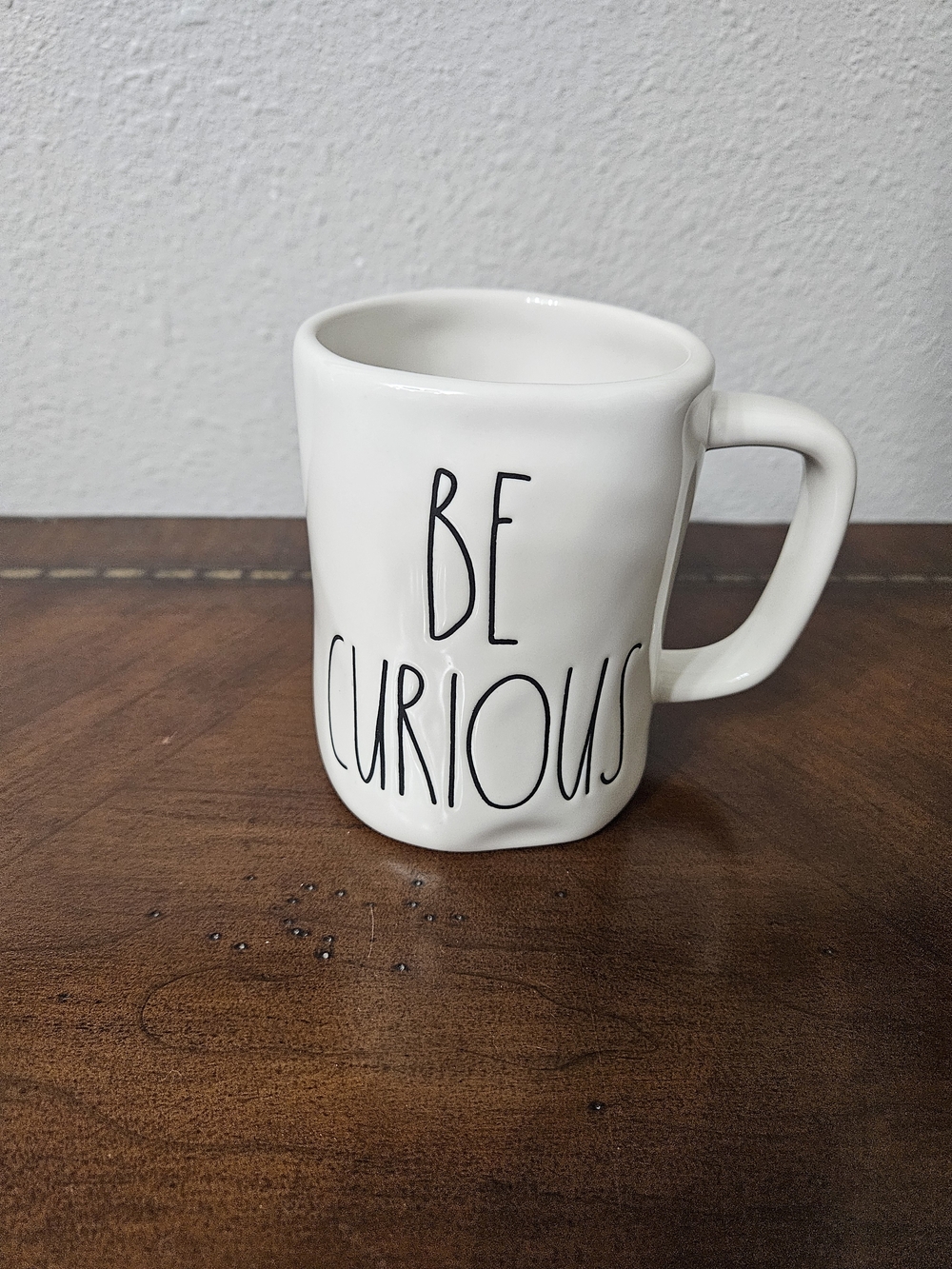 Rae Dunn White Ceramic Mug with Black 'Be Curious' Lettering